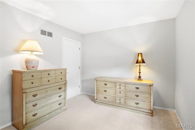 bedroom featuring light carpet and baseboards