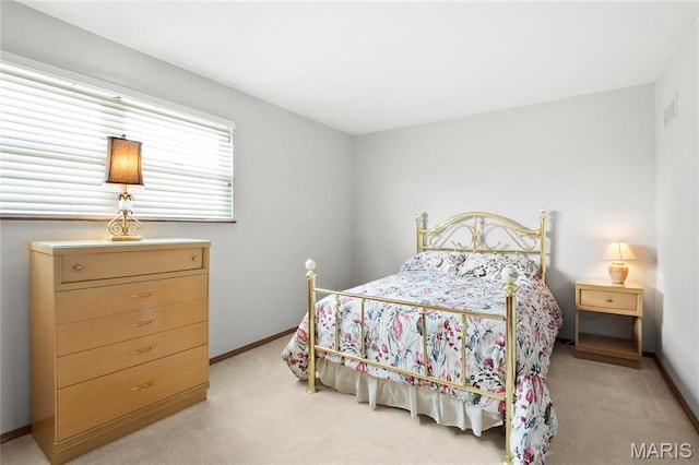 bedroom featuring light colored carpet and baseboards