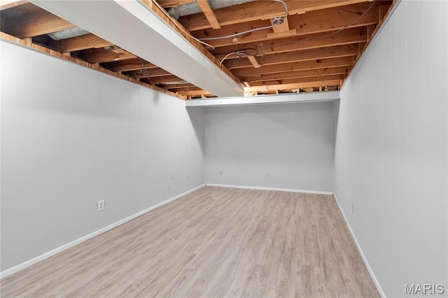 finished basement featuring wood finished floors and baseboards