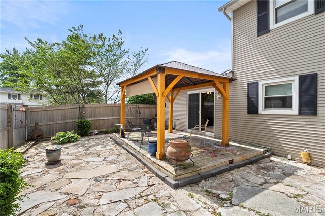 view of patio featuring a gazebo, a fenced backyard, and a deck