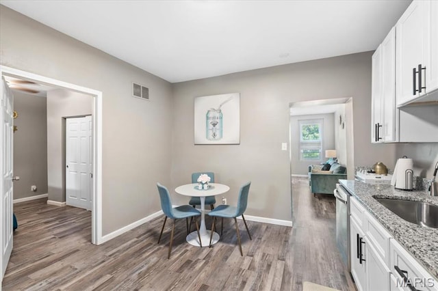 1428 Mallinckrodt, Saint Louis, MO 63107 - dining room featuring light wood-type flooring and baseboards