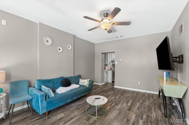 1428 Mallinckrodt, Saint Louis, MO 63107 - living area with dark wood-style flooring, ceiling fan, and baseboards