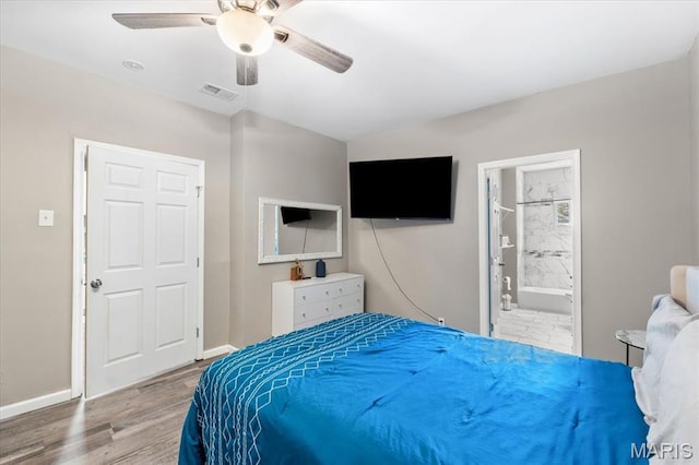1428 Mallinckrodt, Saint Louis, MO 63107 - bedroom featuring baseboards, wood finished floors, a ceiling fan, and connected bathroom