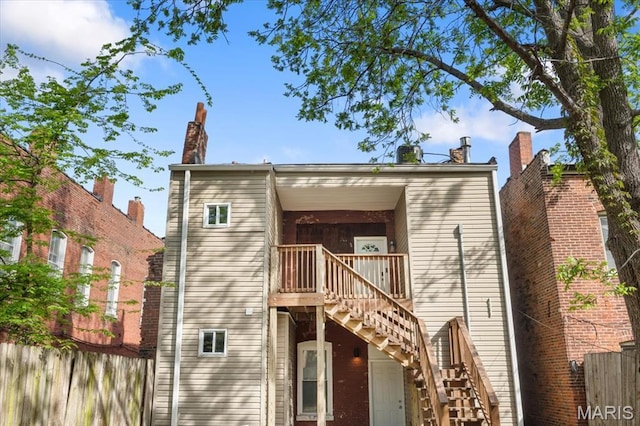 1428 Mallinckrodt, Saint Louis, MO 63107 - rear view of house featuring stairs and fence