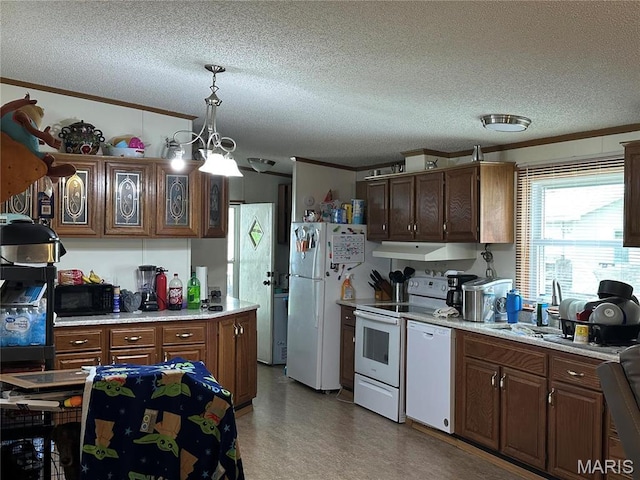 211 N Lucas St, Pilot Knob, MO 63663 - kitchen with white appliances, under cabinet range hood, light countertops, a textured ceiling, and hanging light fixtures