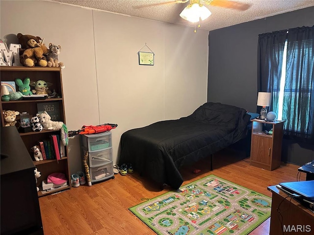 211 N Lucas St, Pilot Knob, MO 63663 - bedroom featuring wood finished floors, a ceiling fan, and a textured ceiling
