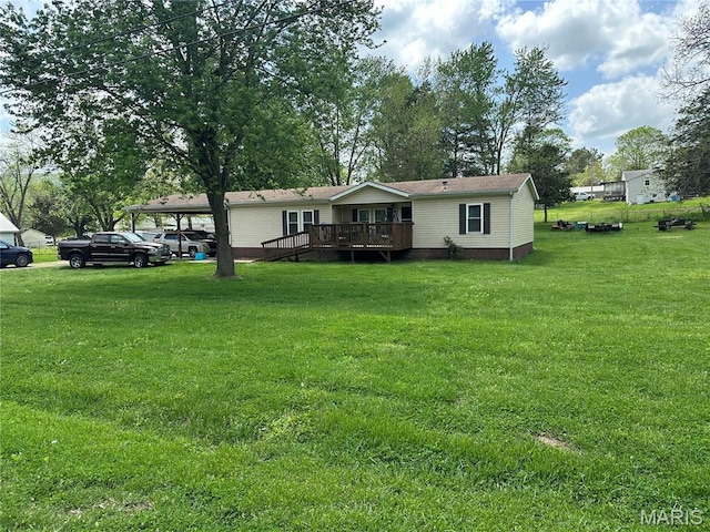 211 N Lucas St, Pilot Knob, MO 63663 - view of front of property with a deck, a front lawn, and a detached carport