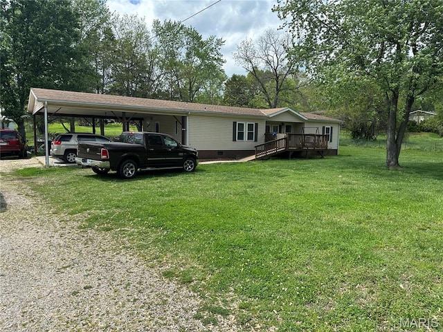 211 N Lucas St, Pilot Knob, MO 63663 - manufactured / mobile home featuring driveway, crawl space, a front yard, a wooden deck, and an attached carport