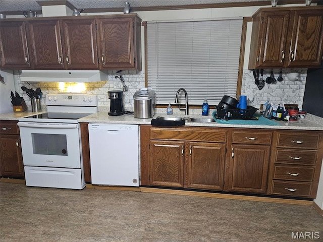 211 N Lucas St, Pilot Knob, MO 63663 - kitchen with white appliances, under cabinet range hood, a sink, tasteful backsplash, and light countertops