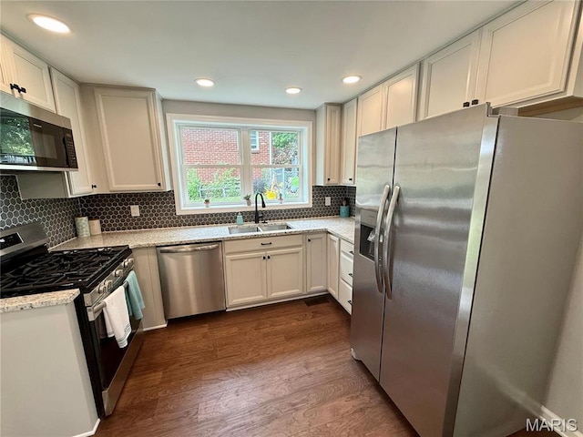 409 Oak St, East Alton, IL 62024 - kitchen featuring stainless steel appliances, a sink, dark wood finished floors, backsplash, and recessed lighting