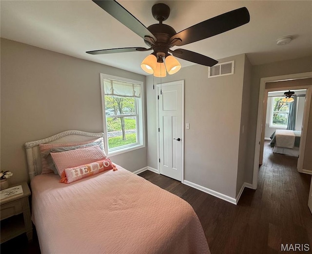 409 Oak St, East Alton, IL 62024 - bedroom with baseboards, dark wood-style flooring, and ceiling fan