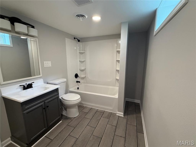 409 Oak St, East Alton, IL 62024 - full bathroom featuring wood finish floors, tub / shower combination, vanity, and toilet