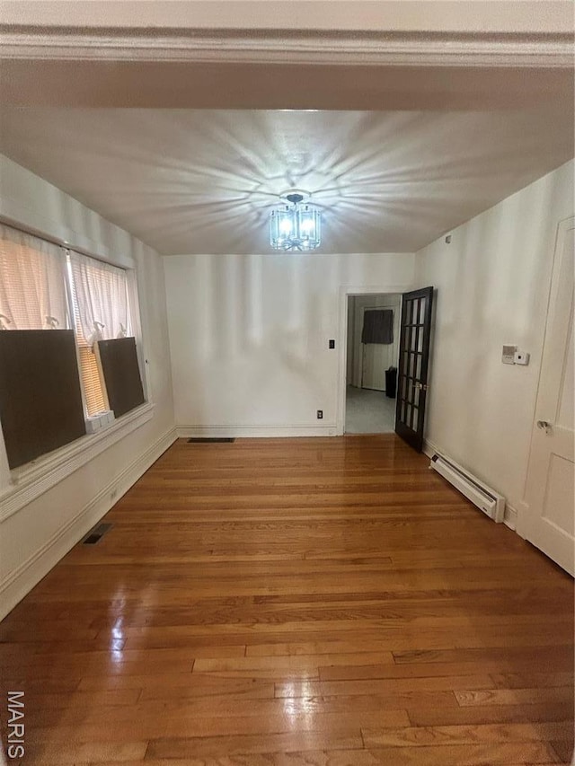 916 Eastgate Ave, Saint Louis, MO 63130 - unfurnished room with a baseboard radiator, wood finished floors, and baseboards