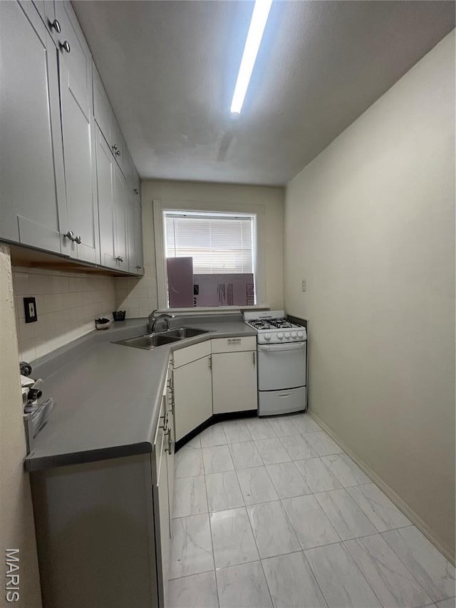 916 Eastgate Ave, Saint Louis, MO 63130 - kitchen with white range with gas stovetop, a sink, light marble finish flooring, and tasteful backsplash