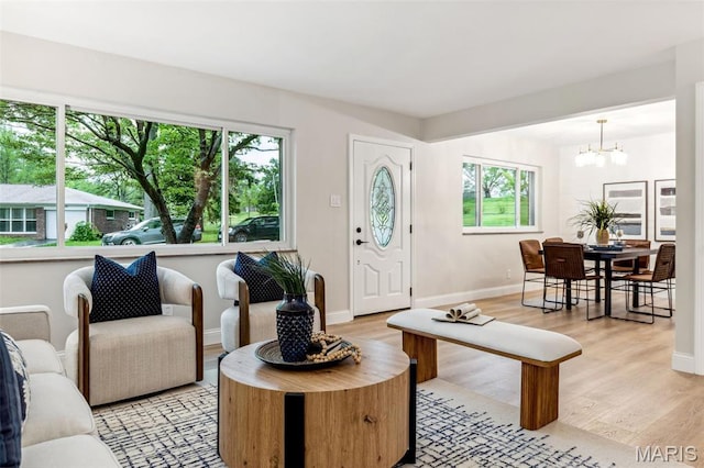 1548 Park Dr Way, Saint Louis, MO 63130 - living area with a chandelier, light wood-style flooring, and baseboards