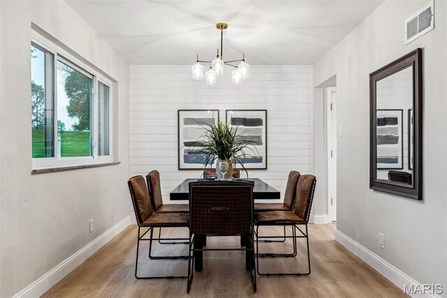 1548 Park Dr Way, Saint Louis, MO 63130 - dining space featuring wood finished floors, a chandelier, and baseboards