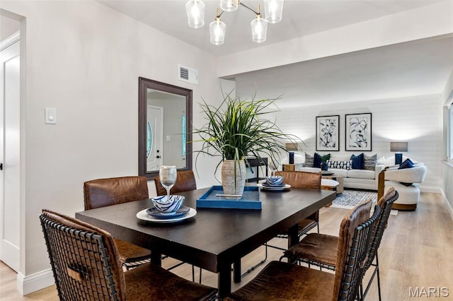 1548 Park Dr Way, Saint Louis, MO 63130 - dining space featuring light wood-style floors, baseboards, and a chandelier