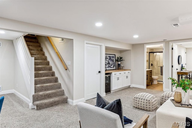 1548 Park Dr Way, Saint Louis, MO 63130 - living room featuring light colored carpet, bar, wine cooler, stairway, and recessed lighting