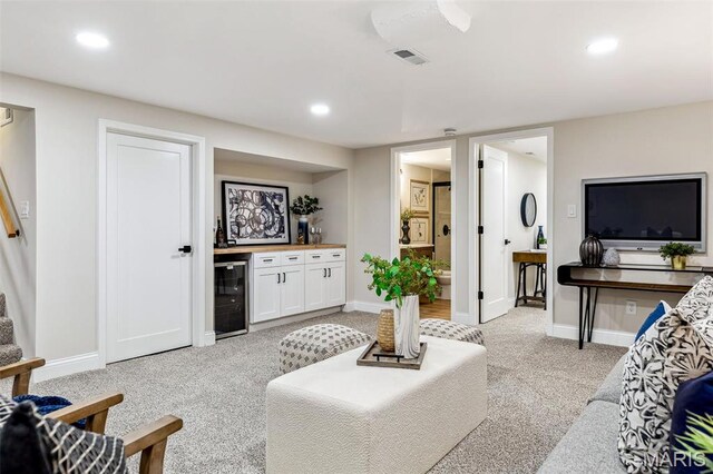 1548 Park Dr Way, Saint Louis, MO 63130 - living room featuring beverage cooler, wet bar, light carpet, baseboards, and stairs