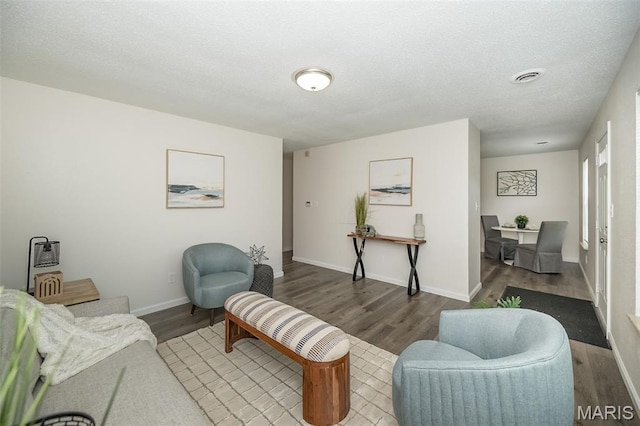 1331 Belrue Ave, Saint Louis, MO 63133 - living room with wood finished floors, baseboards, and a textured ceiling