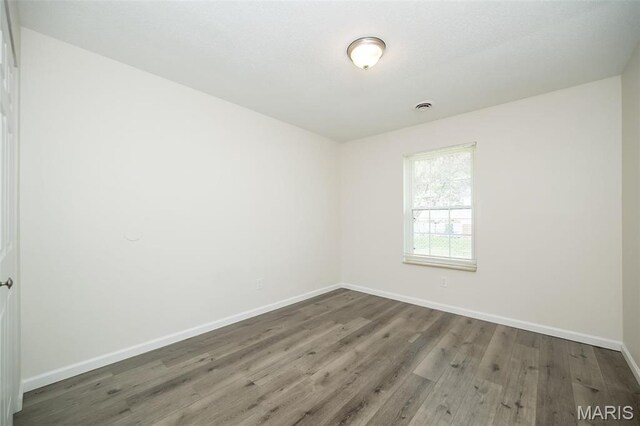 1331 Belrue Ave, Saint Louis, MO 63133 - unfurnished room featuring baseboards and wood finished floors