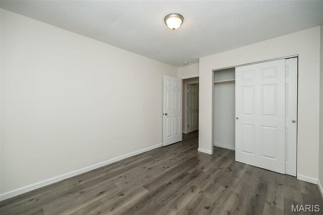 1331 Belrue Ave, Saint Louis, MO 63133 - unfurnished bedroom featuring wood finished floors, baseboards, and a closet