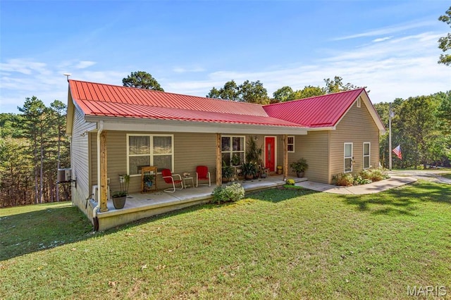 8007 Engleford Rd, Dittmer, MO 63023 - view of front facade with metal roof, covered porch, and a front yard