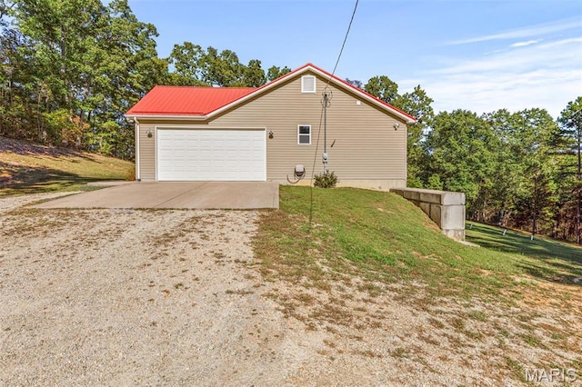 8007 Engleford Rd, Dittmer, MO 63023 - view of side of property featuring dirt driveway, a garage, a lawn, and metal roof