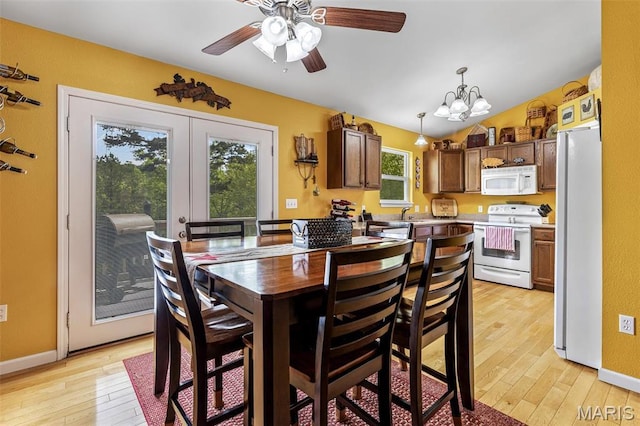 8007 Engleford Rd, Dittmer, MO 63023 - dining area with light wood-type flooring, ceiling fan, french doors, a chandelier, and lofted ceiling