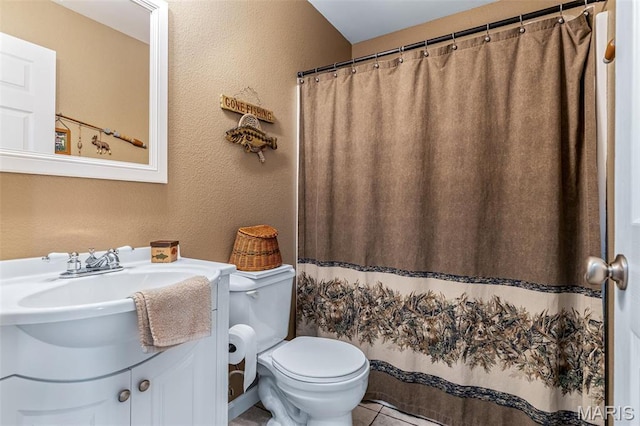 8007 Engleford Rd, Dittmer, MO 63023 - full bathroom featuring toilet, tile patterned floors, vanity, a textured wall, and a shower with shower curtain