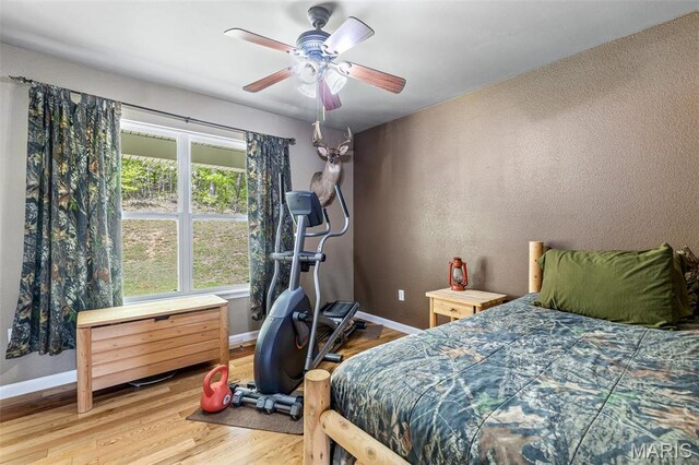 8007 Engleford Rd, Dittmer, MO 63023 - bedroom with baseboards, wood finished floors, and a ceiling fan