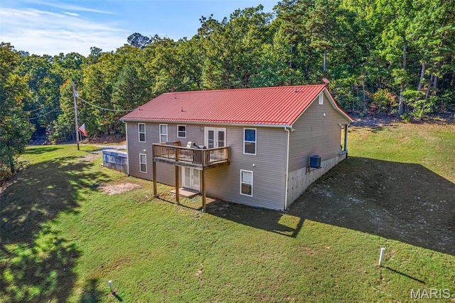 8007 Engleford Rd, Dittmer, MO 63023 - back of property with a yard, a wooden deck, metal roof, and central AC unit