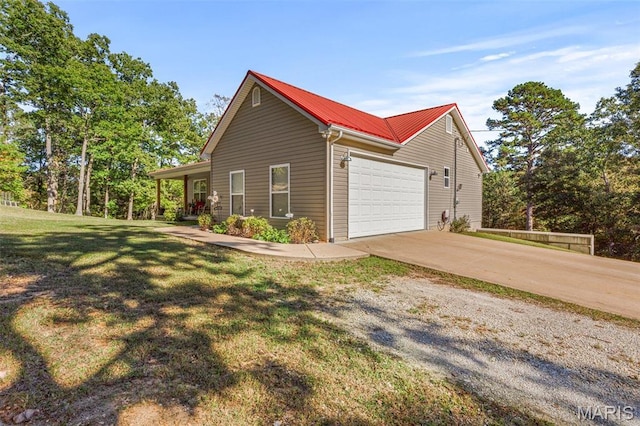 8007 Engleford Rd, Dittmer, MO 63023 - view of side of property with concrete driveway, a garage, metal roof, and a lawn