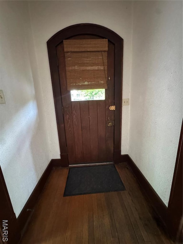 813 Main St, Poplar Bluff, MO 63901 - entryway with dark wood-style flooring, baseboards, and arched walkways