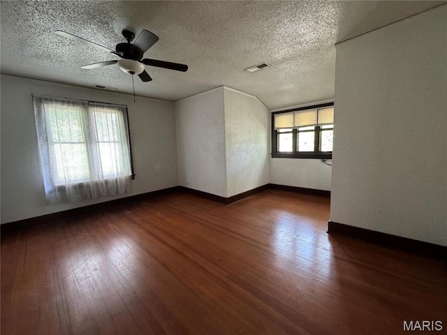 813 Main St, Poplar Bluff, MO 63901 - unfurnished room with dark wood-type flooring, a ceiling fan, a textured ceiling, and baseboards