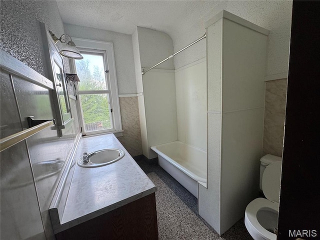 813 Main St, Poplar Bluff, MO 63901 - full bathroom featuring toilet, vanity, a wainscoted wall, bathing tub / shower combination, and a textured ceiling