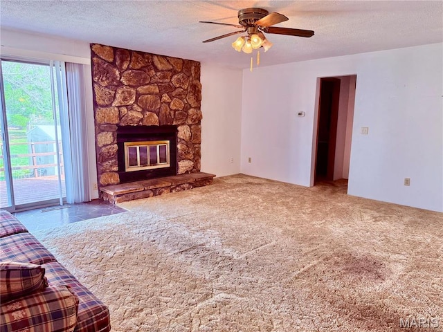 1808 N 15th St, Swansea, IL 62226 - unfurnished living room featuring a ceiling fan, a textured ceiling, a stone fireplace, and carpet floors