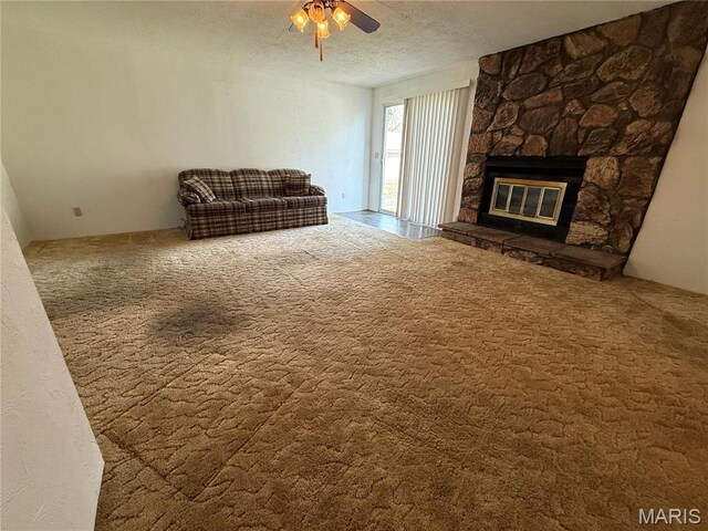 1808 N 15th St, Swansea, IL 62226 - unfurnished living room featuring a ceiling fan, a textured ceiling, a fireplace, and carpet floors