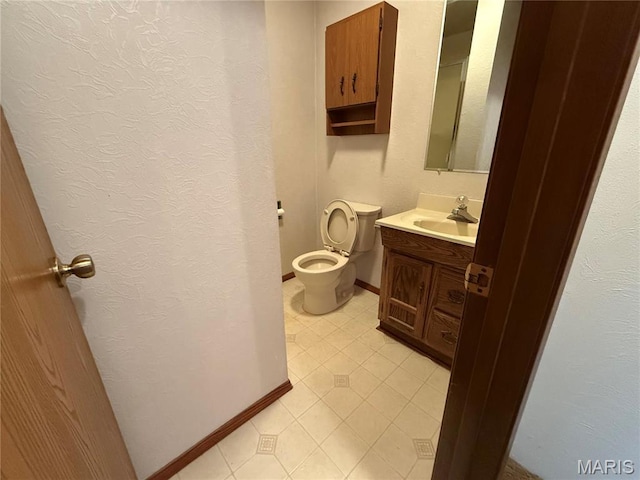 1808 N 15th St, Swansea, IL 62226 - half bathroom featuring tile patterned flooring, baseboards, vanity, toilet, and a textured wall