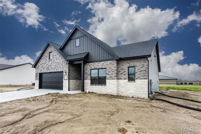 837 Bushwood Way, Ofallon, IL 62269 - view of front facade featuring board and batten siding, driveway, a garage, stone siding, and roof with shingles