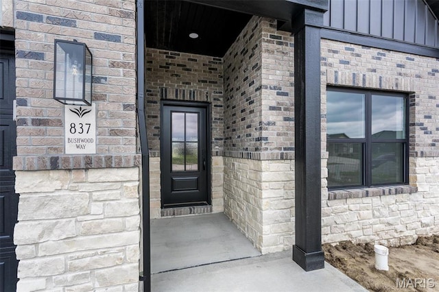 837 Bushwood Way, Ofallon, IL 62269 - doorway to property featuring board and batten siding and brick siding