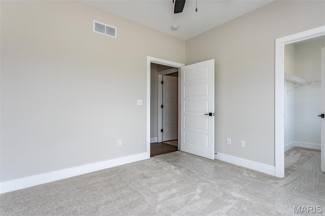 837 Bushwood Way, Ofallon, IL 62269 - unfurnished bedroom featuring carpet flooring, a walk in closet, baseboards, a closet, and a ceiling fan
