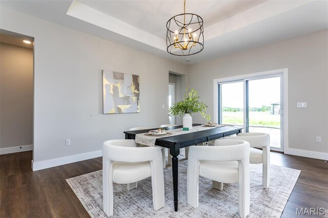837 Bushwood Way, Ofallon, IL 62269 - dining space with baseboards, a chandelier, wood finished floors, and a raised ceiling