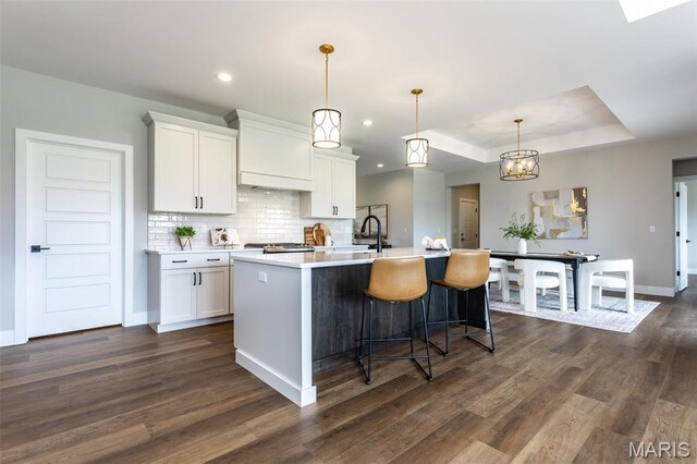 837 Bushwood Way, Ofallon, IL 62269 - kitchen with dark wood-style floors, white cabinets, a center island with sink, light countertops, and recessed lighting