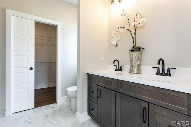 837 Bushwood Way, Ofallon, IL 62269 - bathroom featuring marble finish flooring, toilet, baseboards, a spacious closet, and double vanity