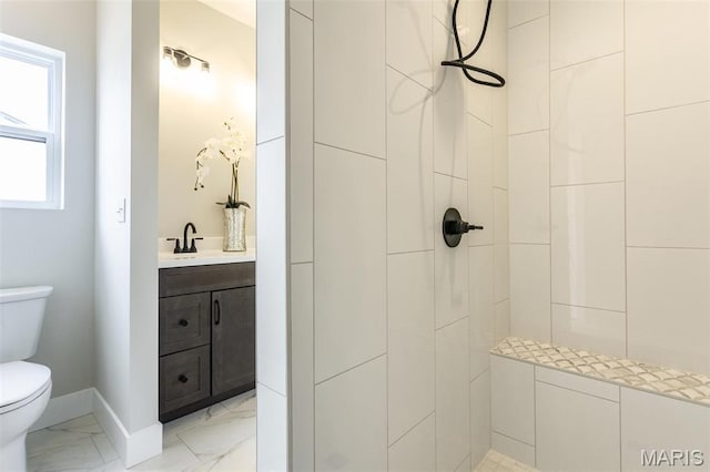 837 Bushwood Way, Ofallon, IL 62269 - bathroom featuring toilet, a tile shower, marble look tile flooring, vanity, and baseboards
