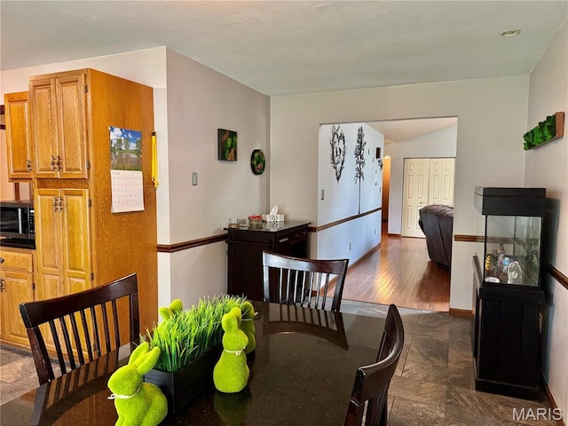 1725 Spruce Hill Dr, Belleville, IL 62221 - dining space with stone tile floors and baseboards