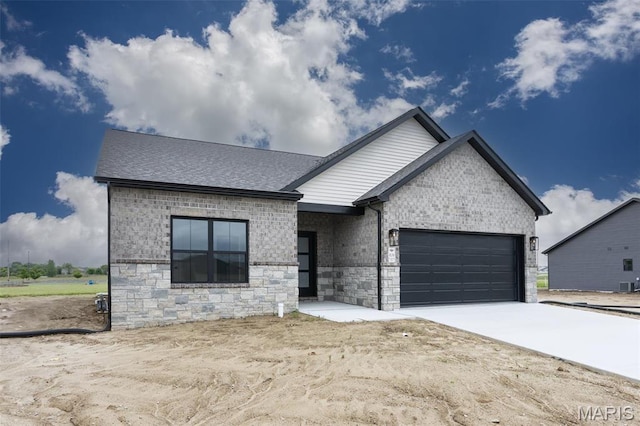 view of front of home with an attached garage, brick siding, concrete driveway, roof with shingles, and stone siding