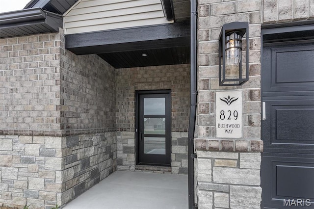 entrance to property featuring stone siding