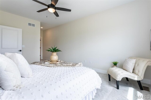 bedroom featuring light carpet, baseboards, and a ceiling fan
